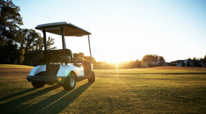 Shot of an empty golf cart parked on a green