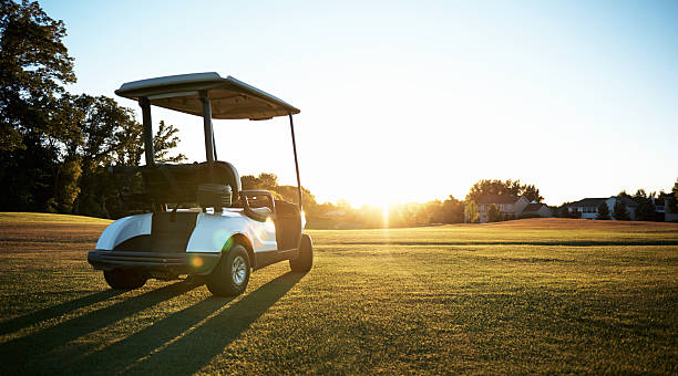 Shot of an empty golf cart parked on a green